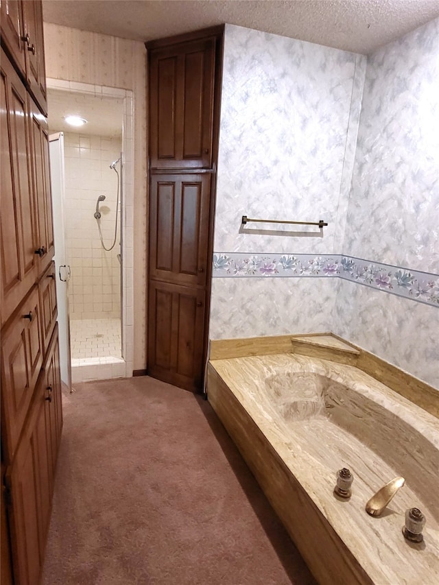 697 Highland Crest Dr, Hurst, TX 76054 - bathroom featuring wallpapered walls, a shower stall, a bath, and a textured ceiling