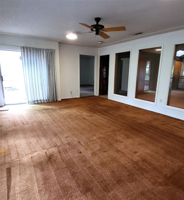 697 Highland Crest Dr, Hurst, TX 76054 - empty room with plenty of natural light, carpet floors, a ceiling fan, and a textured ceiling