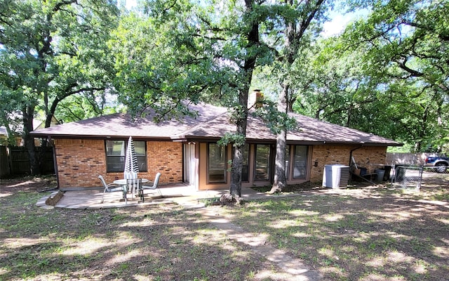 697 Highland Crest Dr, Hurst, TX 76054 - rear view of house featuring brick siding, a patio, and a chimney
