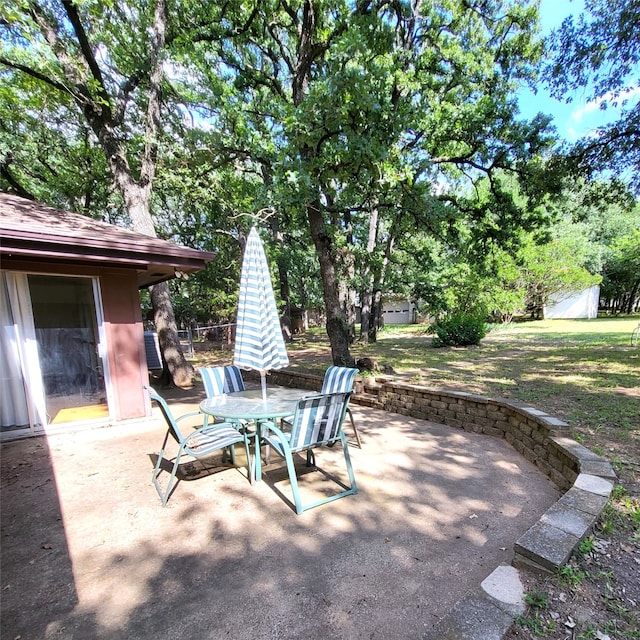 697 Highland Crest Dr, Hurst, TX 76054 - view of patio / terrace with outdoor dining space and an outbuilding