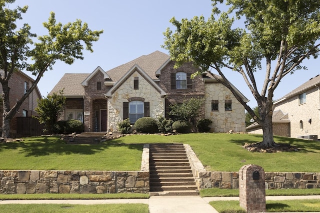 1970 Lake Forest Dr, Rockwall, TX 75087 - french country home featuring stone siding, a front lawn, and stairs
