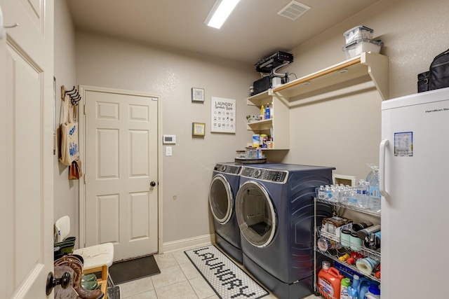 1970 Lake Forest Dr, Rockwall, TX 75087 - washroom featuring washer and clothes dryer and light tile patterned floors