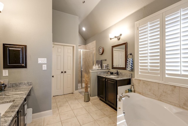 1970 Lake Forest Dr, Rockwall, TX 75087 - bathroom featuring vaulted ceiling, two vanities, tile patterned floors, a shower stall, and a bath