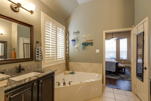 1970 Lake Forest Dr, Rockwall, TX 75087 - bathroom featuring ensuite bathroom, vanity, a bath, vaulted ceiling, and tile patterned floors