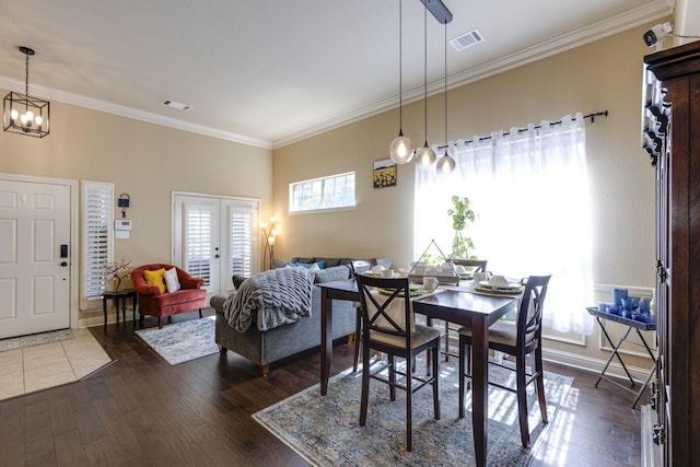 1970 Lake Forest Dr, Rockwall, TX 75087 - dining room with dark wood finished floors, crown molding, french doors, and a chandelier