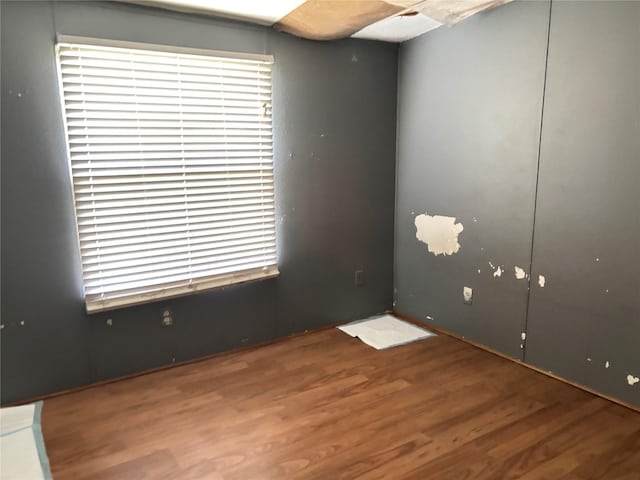 295 Denton Heights Ln, Weatherford, TX 76085 - empty room with wood finished floors and healthy amount of natural light