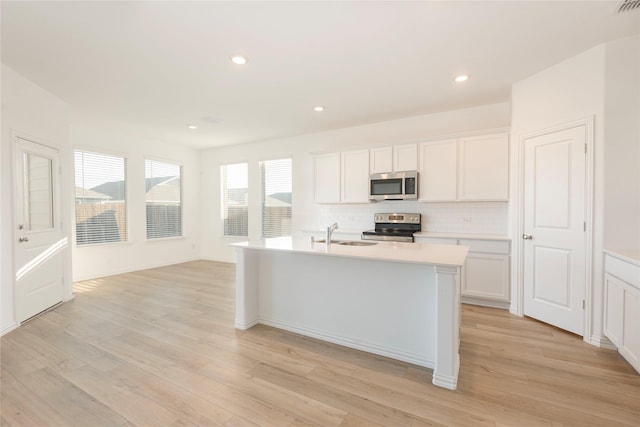 219 Autumn Sage Ln, Princeton, TX 75407 - kitchen featuring appliances with stainless steel finishes, tasteful backsplash, light countertops, light wood-style flooring, and recessed lighting
