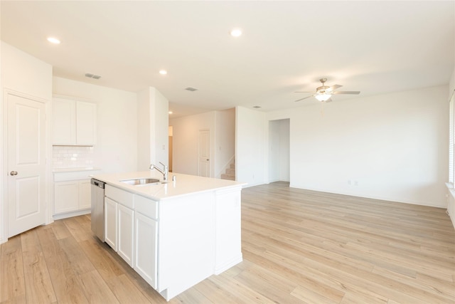 219 Autumn Sage Ln, Princeton, TX 75407 - kitchen with dishwasher, light wood-style floors, ceiling fan, a kitchen island with sink, and tasteful backsplash