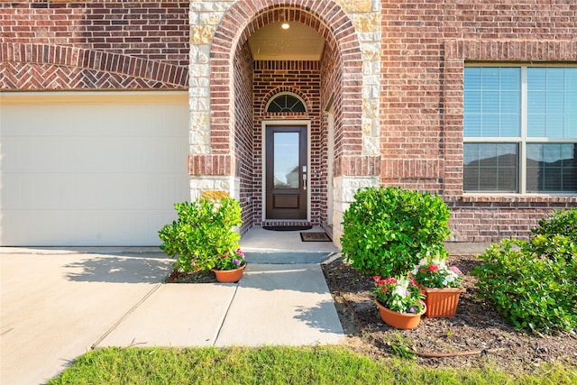 219 Autumn Sage Ln, Princeton, TX 75407 - property entrance with brick siding, driveway, and an attached garage