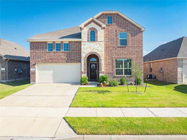 219 Autumn Sage Ln, Princeton, TX 75407 - view of front of home featuring brick siding, a garage, driveway, a front lawn, and stone siding
