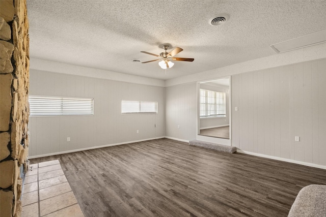 2405 Patricia Ln, Garland, TX 75041 - unfurnished room with wood finished floors, ceiling fan, and a textured ceiling