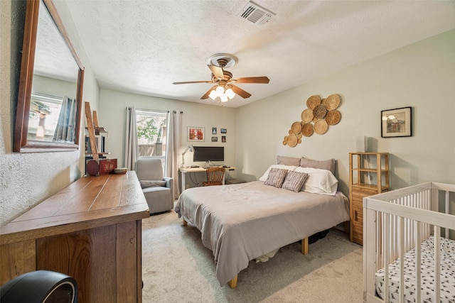 2924 Whitemarsh Cir, Richardson, TX 75080 - bedroom with light colored carpet, a textured ceiling, an office area, and a ceiling fan