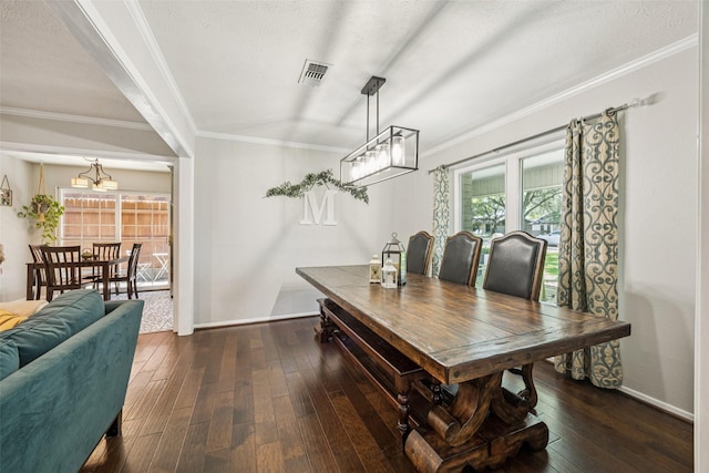 2924 Whitemarsh Cir, Richardson, TX 75080 - dining area with ornamental molding, dark wood-style flooring, and a chandelier