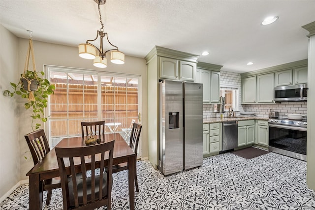 2924 Whitemarsh Cir, Richardson, TX 75080 - kitchen featuring stainless steel appliances, decorative backsplash, recessed lighting, pendant lighting, and a chandelier