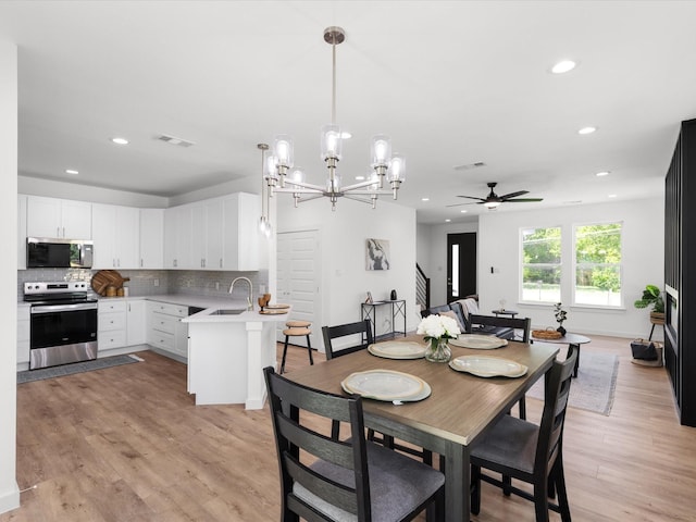 5223 Willie St, Fort Worth, TX 76105 - dining area with ceiling fan, recessed lighting, light wood-style flooring, and a chandelier