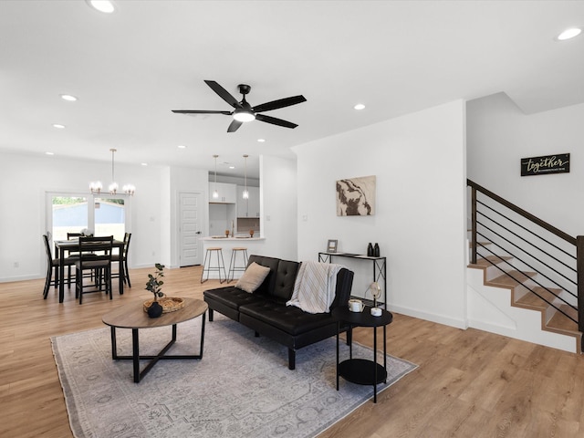 5223 Willie St, Fort Worth, TX 76105 - living area featuring light wood-type flooring, recessed lighting, ceiling fan, stairs, and a chandelier