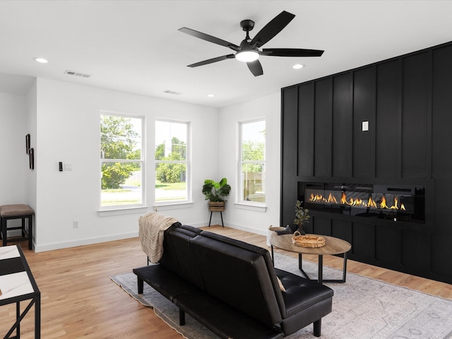 5223 Willie St, Fort Worth, TX 76105 - living area with a fireplace, light wood finished floors, a ceiling fan, and recessed lighting