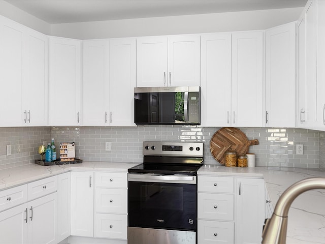 5223 Willie St, Fort Worth, TX 76105 - kitchen with stainless steel appliances, light stone countertops, and white cabinets