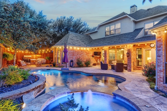 11640 Mesa Verde Dr, Frisco, TX 75033 - pool at dusk featuring an outdoor living space, a patio area, a fenced backyard, and a pool with connected hot tub