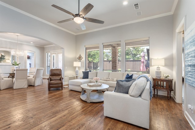 11640 Mesa Verde Dr, Frisco, TX 75033 - living area with wood finished floors, healthy amount of natural light, arched walkways, a ceiling fan, and crown molding