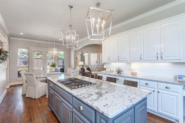 11640 Mesa Verde Dr, Frisco, TX 75033 - kitchen featuring a chandelier, stainless steel gas cooktop, white cabinets, arched walkways, and dark wood-style flooring