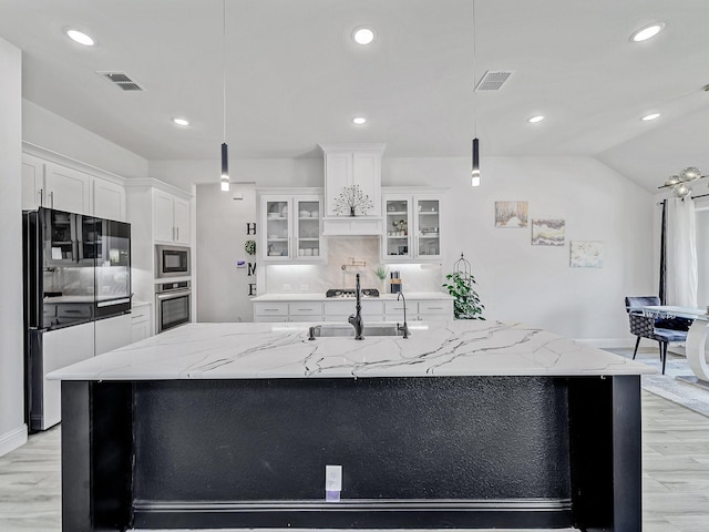 412 Navo Rd, Little Elm, TX 75068 - kitchen featuring stainless steel appliances, a large island with sink, white cabinets, glass insert cabinets, and recessed lighting