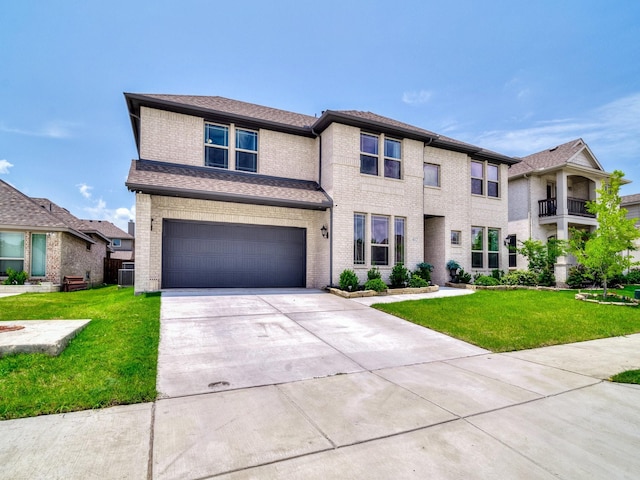 412 Navo Rd, Little Elm, TX 75068 - view of front facade featuring concrete driveway, an attached garage, a front lawn, and brick siding