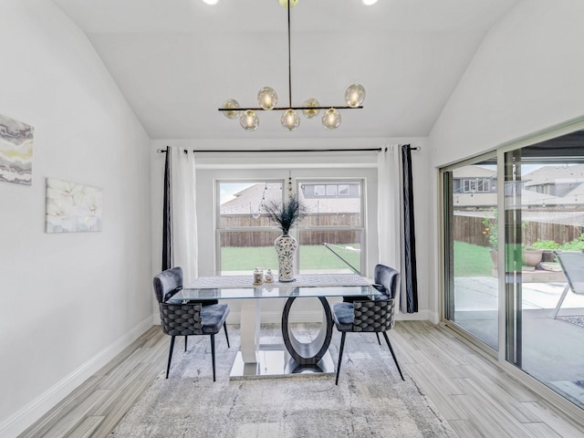 412 Navo Rd, Little Elm, TX 75068 - dining space with vaulted ceiling, a chandelier, and wood finished floors