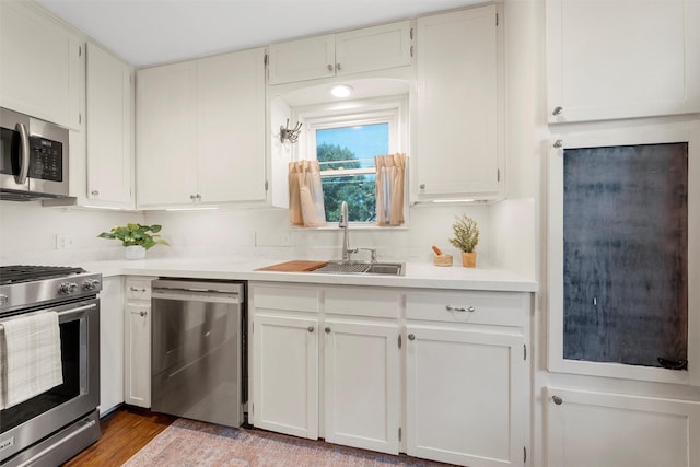5819 Fairview Dr, Waco, TX 76710 - kitchen with stainless steel appliances, light countertops, white cabinets, and light wood-type flooring
