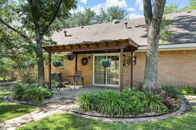 5819 Fairview Dr, Waco, TX 76710 - back of house with a shingled roof, a patio, and brick siding