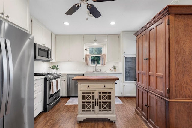 5819 Fairview Dr, Waco, TX 76710 - kitchen with stainless steel appliances, ceiling fan, dark wood-style floors, a kitchen island, and recessed lighting