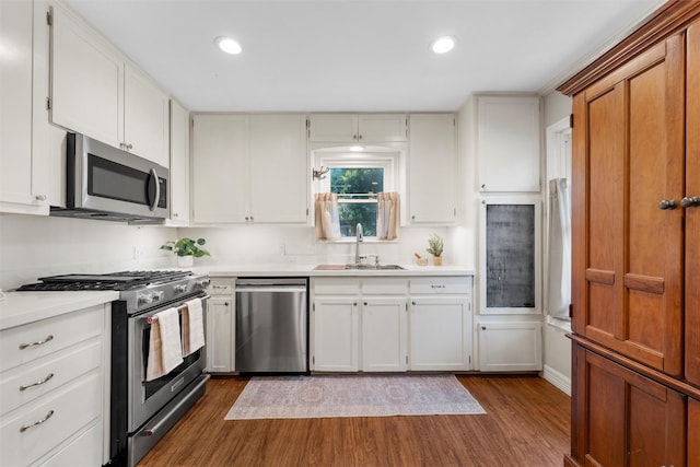 5819 Fairview Dr, Waco, TX 76710 - kitchen featuring appliances with stainless steel finishes, dark wood-style floors, light countertops, recessed lighting, and white cabinets