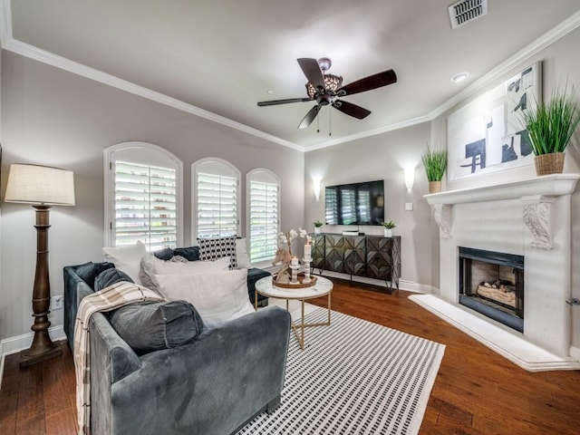1901 Desoto Dr, Mckinney, TX 75072 - living room with ornamental molding, a ceiling fan, a fireplace with raised hearth, and wood finished floors