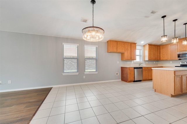 3016 Bryce Dr, Wylie, TX 75098 - kitchen featuring stainless steel appliances, light countertops, a chandelier, and hanging light fixtures