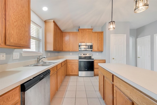 3016 Bryce Dr, Wylie, TX 75098 - kitchen featuring appliances with stainless steel finishes, light countertops, hanging light fixtures, light tile patterned floors, and vaulted ceiling