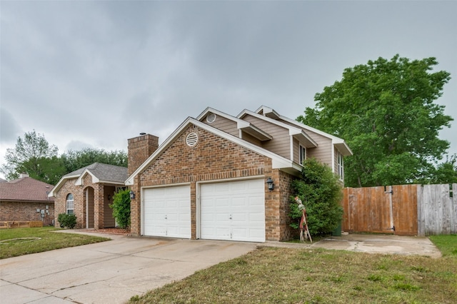 224 Iberis Dr, Arlington, TX 76018 - view of front of property featuring a garage, concrete driveway, brick siding, and a chimney