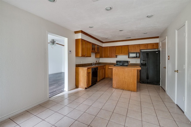 224 Iberis Dr, Arlington, TX 76018 - kitchen featuring black appliances, a center island, light tile patterned floors, and brown cabinetry