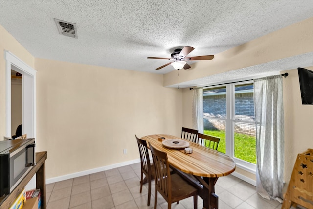 7612 Creekmoore Dr, Fort Worth, TX 76133 - dining area featuring ceiling fan, a textured ceiling, and light tile patterned floors