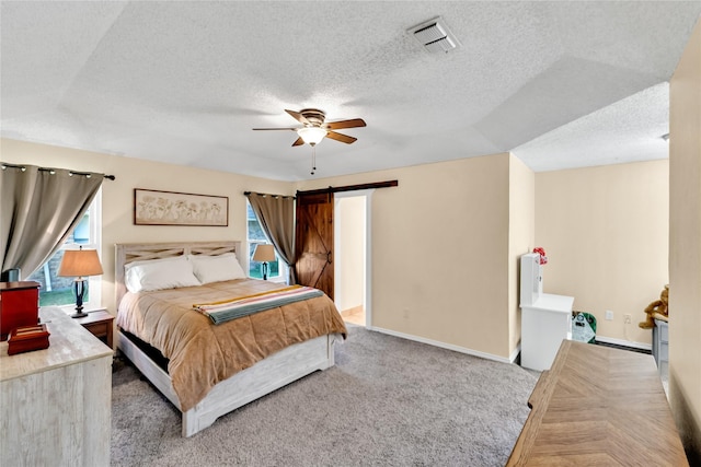 7612 Creekmoore Dr, Fort Worth, TX 76133 - bedroom with a textured ceiling, a barn door, carpet floors, and a ceiling fan