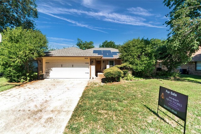 7612 Creekmoore Dr, Fort Worth, TX 76133 - view of front of house with an attached garage, roof mounted solar panels, driveway, a front yard, and a shingled roof