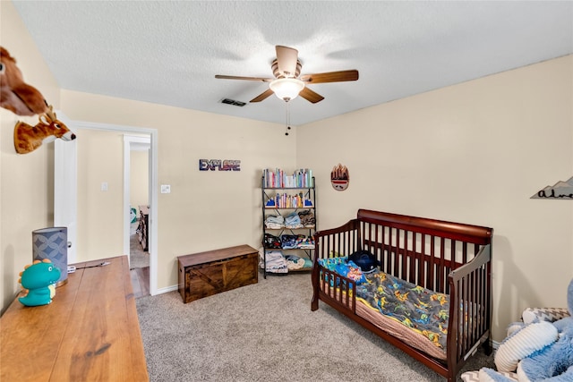 7612 Creekmoore Dr, Fort Worth, TX 76133 - bedroom featuring ceiling fan, carpet flooring, and a crib