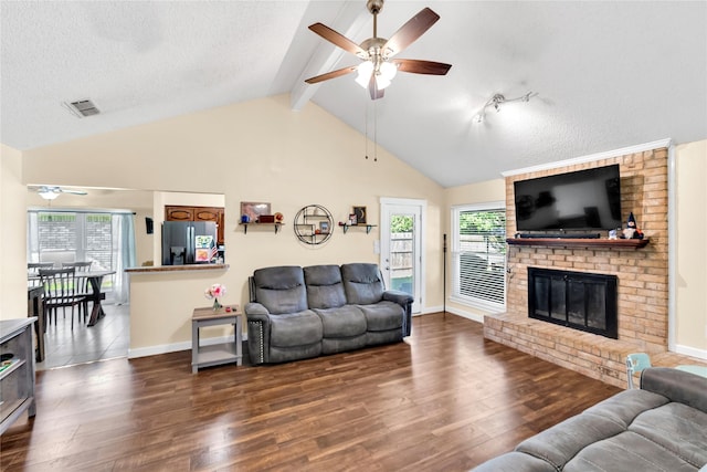 7612 Creekmoore Dr, Fort Worth, TX 76133 - living area featuring a ceiling fan, wood finished floors, a fireplace, and a textured ceiling