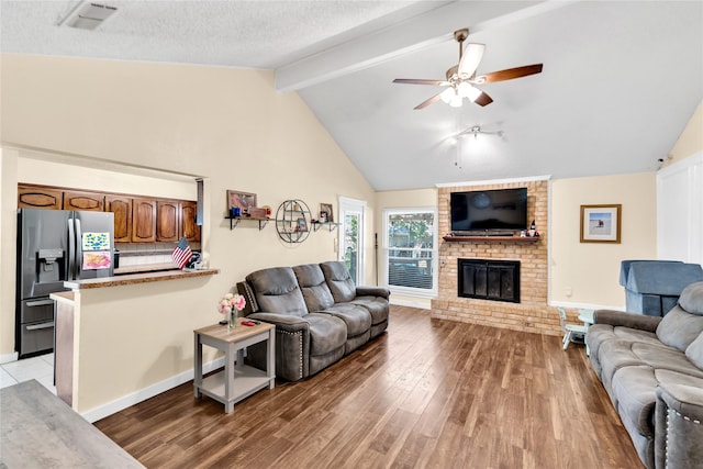 7612 Creekmoore Dr, Fort Worth, TX 76133 - living room featuring light wood-type flooring, a brick fireplace, ceiling fan, beamed ceiling, and high vaulted ceiling