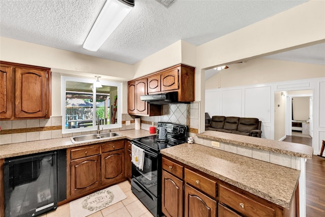 7612 Creekmoore Dr, Fort Worth, TX 76133 - kitchen with black appliances, a peninsula, brown cabinetry, backsplash, and light countertops