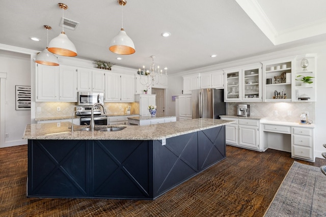 1212 Chandler Cir, Prosper, TX 75078 - kitchen featuring appliances with stainless steel finishes, a large island, white cabinetry, recessed lighting, and backsplash