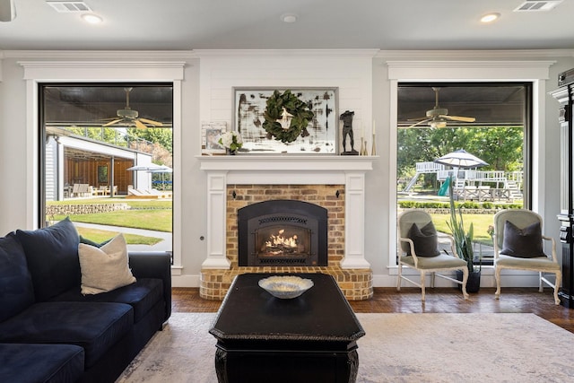 1212 Chandler Cir, Prosper, TX 75078 - living area featuring a ceiling fan, a brick fireplace, wood finished floors, and crown molding