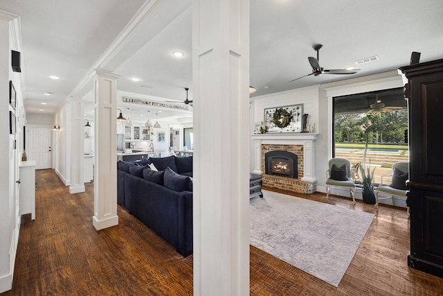 1212 Chandler Cir, Prosper, TX 75078 - living area featuring a ceiling fan, decorative columns, a brick fireplace, dark wood finished floors, and recessed lighting