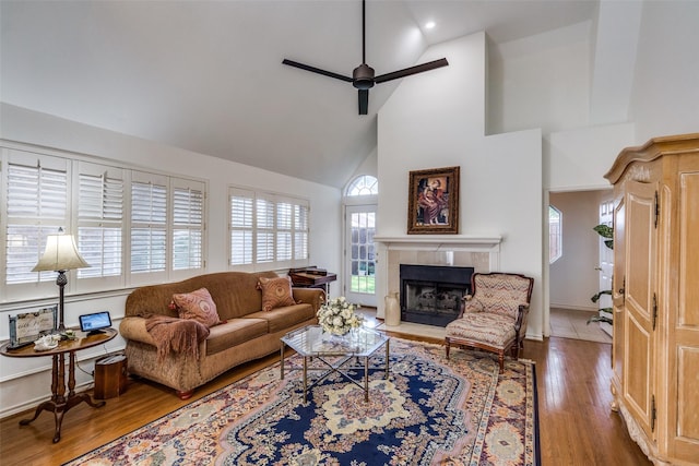 1908 Vantage Dr, Plano, TX 75075 - living area featuring high vaulted ceiling, a ceiling fan, a tiled fireplace, and wood finished floors