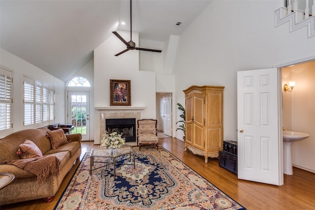 1908 Vantage Dr, Plano, TX 75075 - living room featuring high vaulted ceiling, a tile fireplace, ceiling fan, and wood finished floors