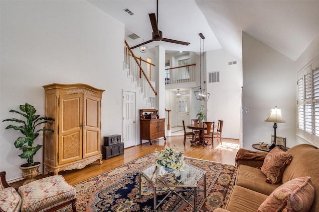 1908 Vantage Dr, Plano, TX 75075 - living room featuring light wood finished floors, stairs, high vaulted ceiling, and a ceiling fan